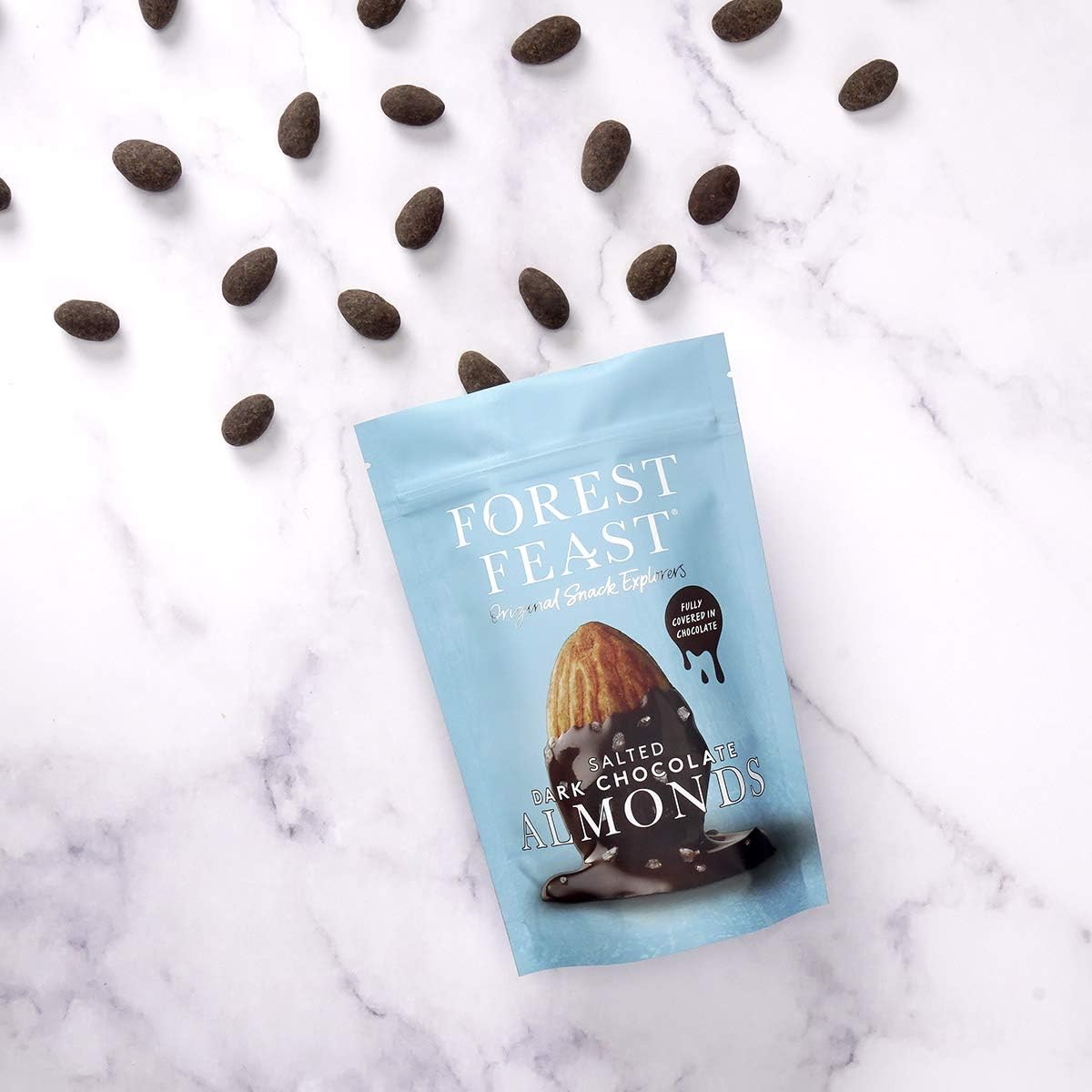 opened pack of Forest Feast Salted Dark Chocolate Almonds Chocolate with the almonds falling out