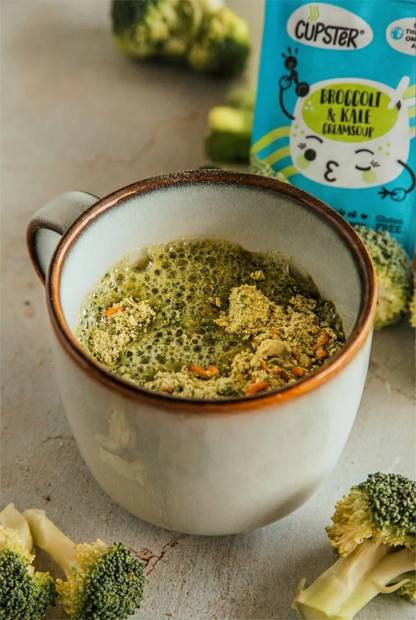 Cupster instant broccoli - kale cream soup in a mug showing the pwder being absorbed into the soup