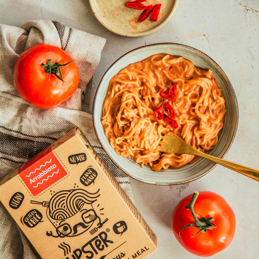 Cupster Instant Arrabbiata Pasta 97g cooked with the packaging next to the plate