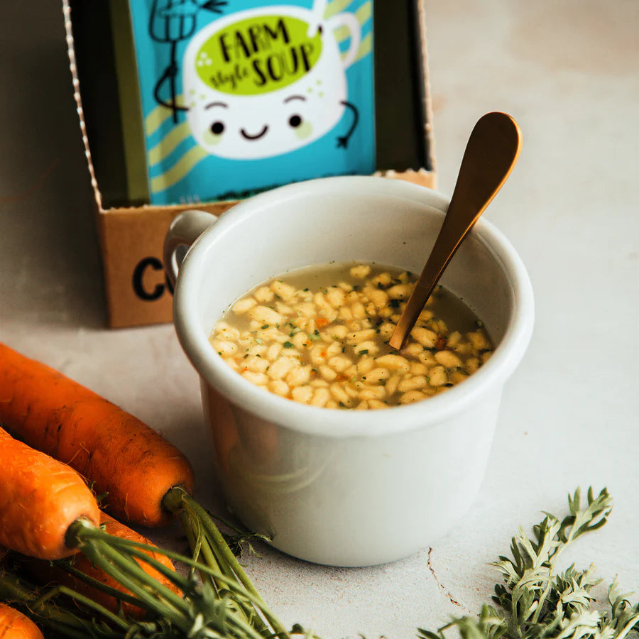A white ceramic bowl filled with Cupster instant farm style soup 