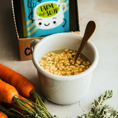 A white ceramic bowl filled with Cupster instant farm style soup 